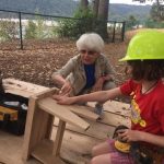 Susie helps girl with stool